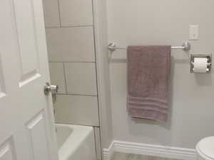 Bathroom with toilet and tub / shower combination