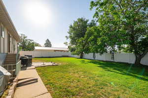 Fenced backyard featuring a patio