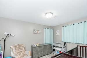 Carpeted bedroom with a crib