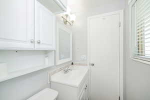 Bathroom featuring vanity and toilet