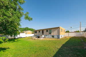 Rear view of property featuring a fenced backyard
