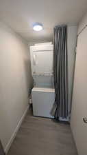 Laundry area with included stacked washer and clothes dryer