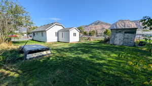 View of yard with a storage shed and a mountain view