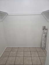 Spacious closet featuring light tile patterned flooring