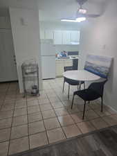 Dining area with light tile patterned floors and baseboards