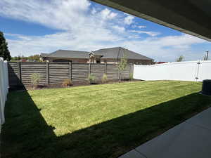 Fenced backyard with a patio area