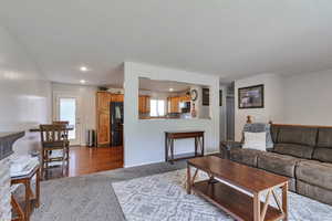Living room with dark colored carpet, recessed lighting, and a textured ceiling