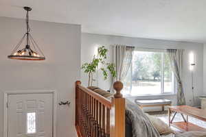Living room with a textured ceiling and a chandelier