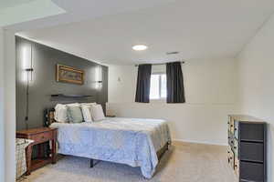 Carpeted bedroom with baseboards