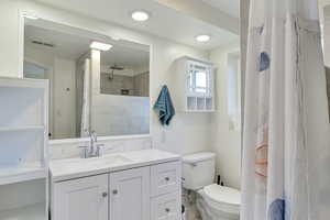 Bathroom featuring vanity and a tile shower