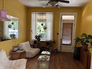 353 W. living room with hardwood floors, large window and high ceilings