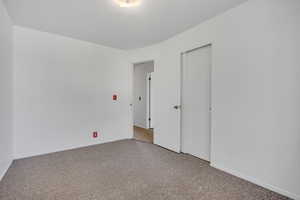 Unfurnished room featuring baseboards and carpet flooring