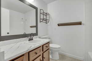 Bathroom with vanity and light tile patterned flooring