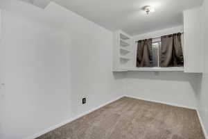 Carpeted spare room with baseboards