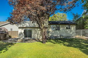 Back of property featuring a fenced backyard and a patio
