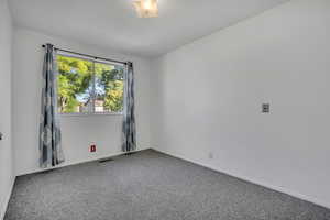 Unfurnished room featuring carpet flooring and baseboards