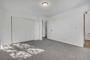 Unfurnished bedroom with a closet and carpet