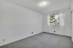 Unfurnished room with baseboards and carpet floors