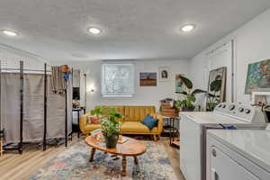 Unit B living and laundry with light lvp finished floors.