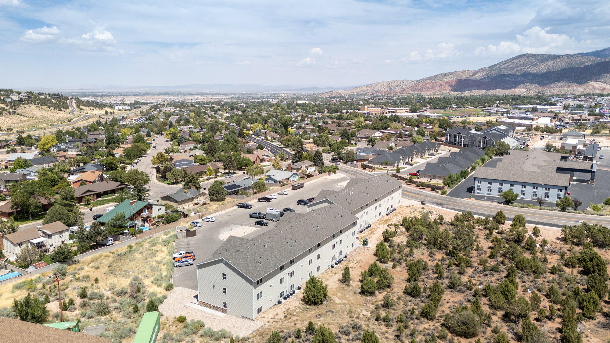 Aerial perspective of suburban area featuring a mountain backdrop