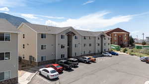 View of property featuring uncovered parking