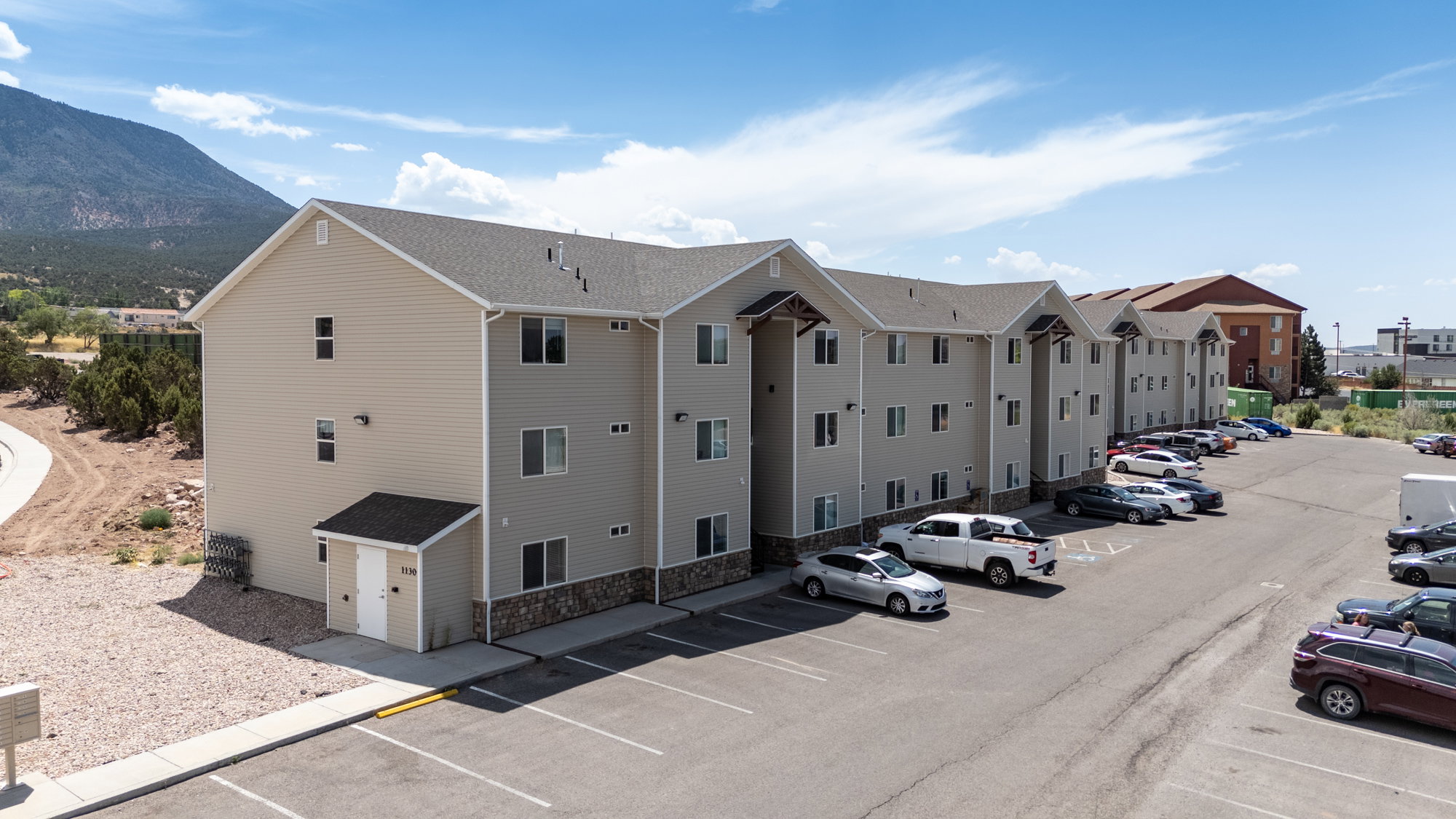 View of property featuring uncovered parking