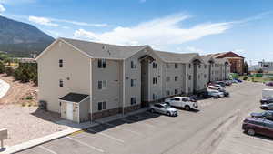 View of property featuring uncovered parking