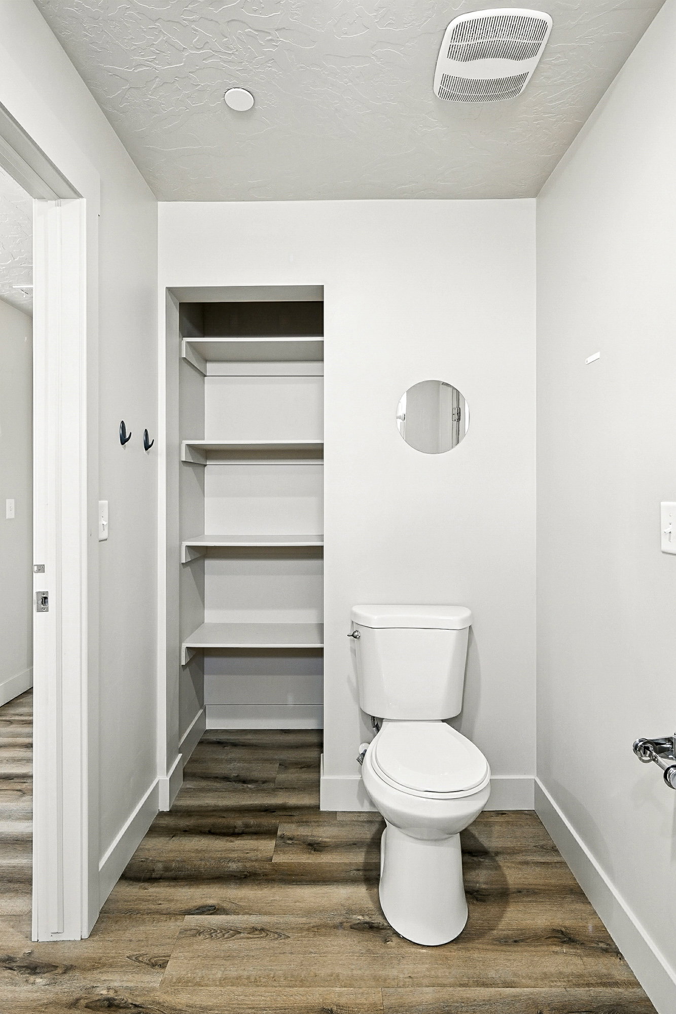 Bathroom with dark wood-type flooring, a textured ceiling, and recessed lighting