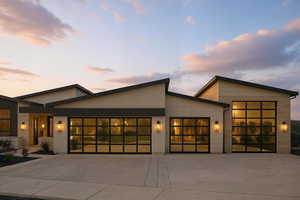Contemporary house featuring an attached garage and concrete driveway