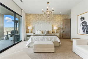 Carpeted bedroom with access to exterior, a chandelier, wallpapered walls, and recessed lighting