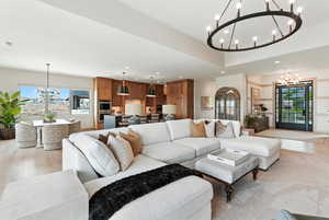 Living room with a chandelier, recessed lighting, and wood finished floors