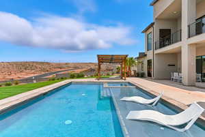 View of swimming pool with a pergola, a patio area, and a pool with connected hot tub