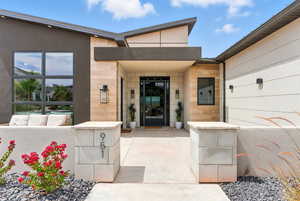 Entrance to property featuring stone siding