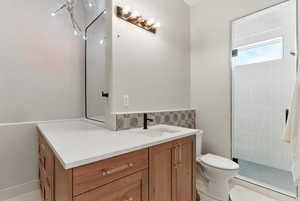 Bathroom featuring vanity, a stall shower, and light tile patterned floors