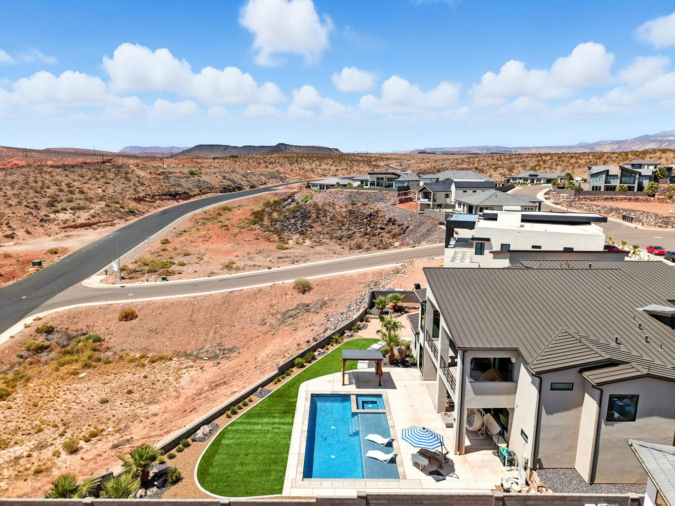 View of subject property with a pool area and a mountain backdrop