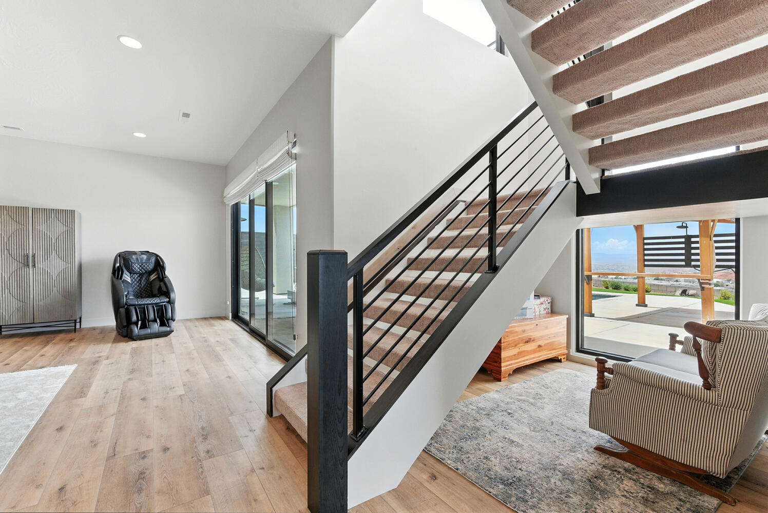 Staircase with wood-type flooring and recessed lighting
