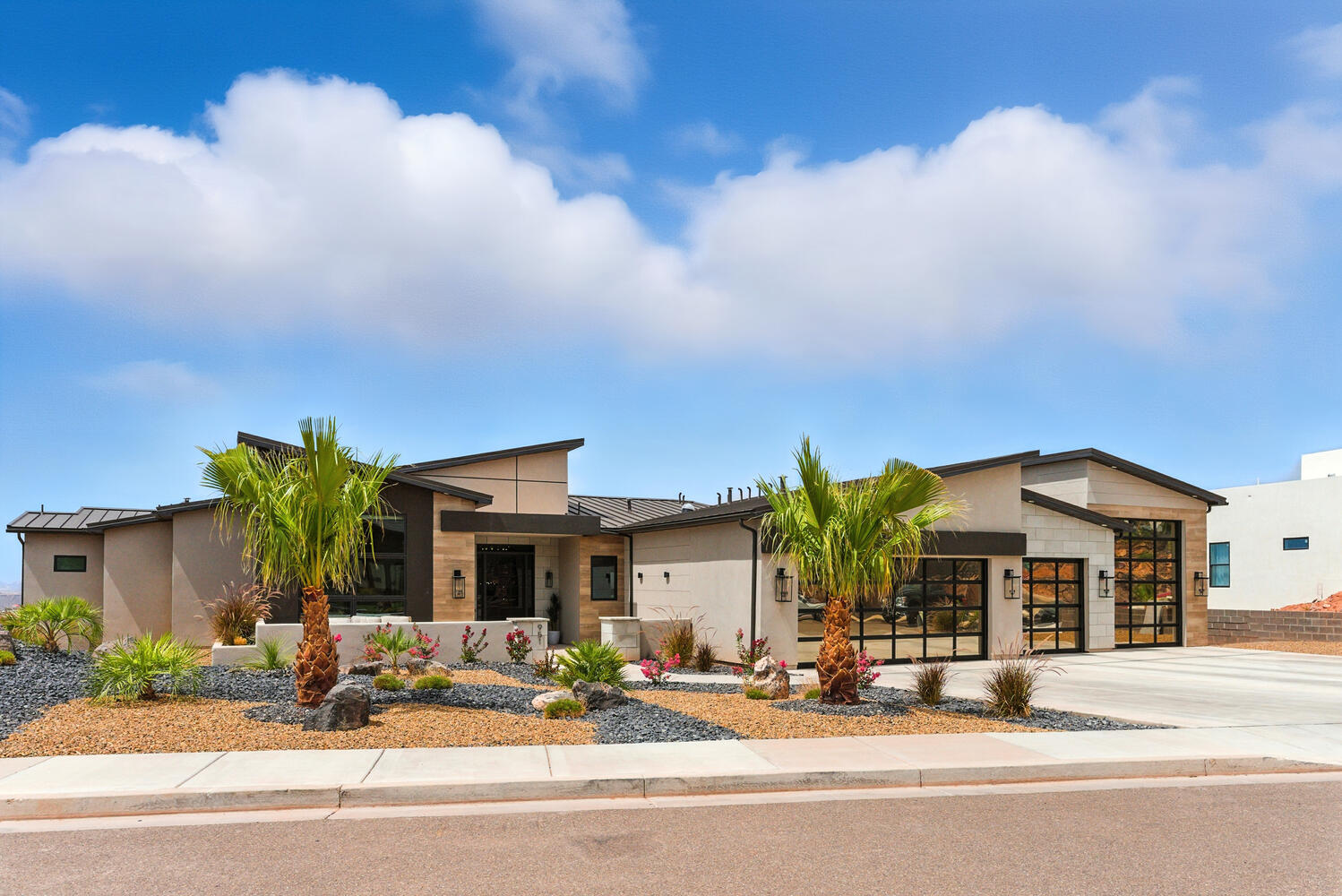 Contemporary home featuring driveway, a standing seam roof, and a metal roof