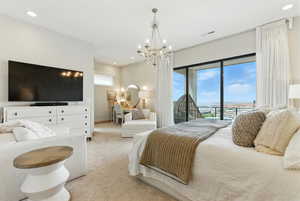 Carpeted bedroom with recessed lighting, access to outside, and a chandelier