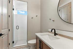 Full bathroom with a stall shower, vanity, and light tile patterned floors