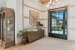 Doorway with a chandelier and wood finished floors