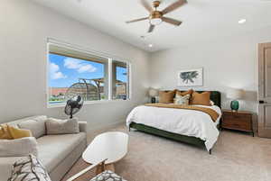 Carpeted bedroom featuring a ceiling fan and recessed lighting