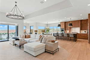 Living room with a chandelier, recessed lighting, and light wood finished floors