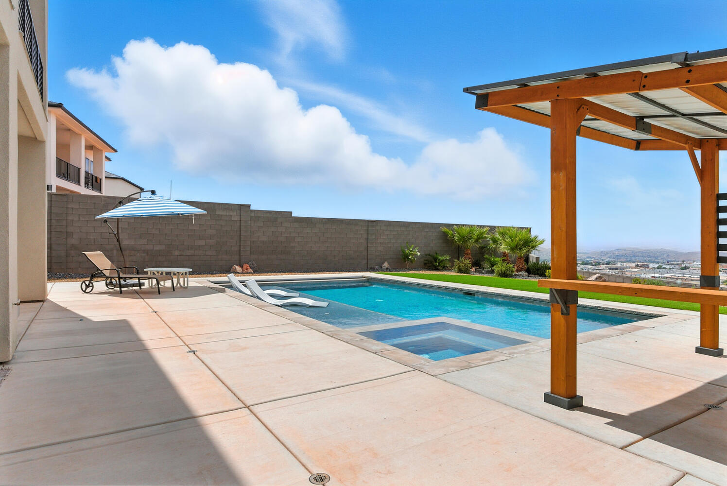 View of pool with a patio area, a pool with connected hot tub, and a fenced backyard