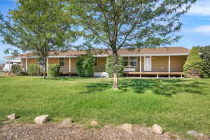 Back of property featuring a yard