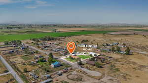 Aerial view of property and surrounding area with rural landscape and a mountain backdrop