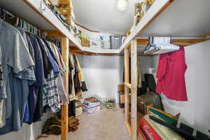 Spacious closet with light colored carpet