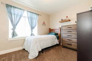 Bedroom featuring carpet flooring and baseboards