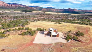 Aerial view of property and surrounding area with mountains
