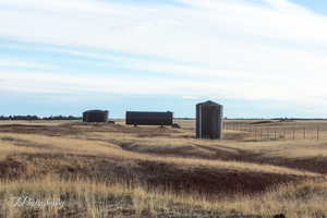 View of yard with a rural view and an outdoor structure