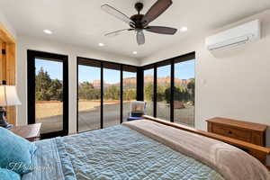 Bedroom with access to outside, an AC wall unit, recessed lighting, a mountain view, and a textured ceiling